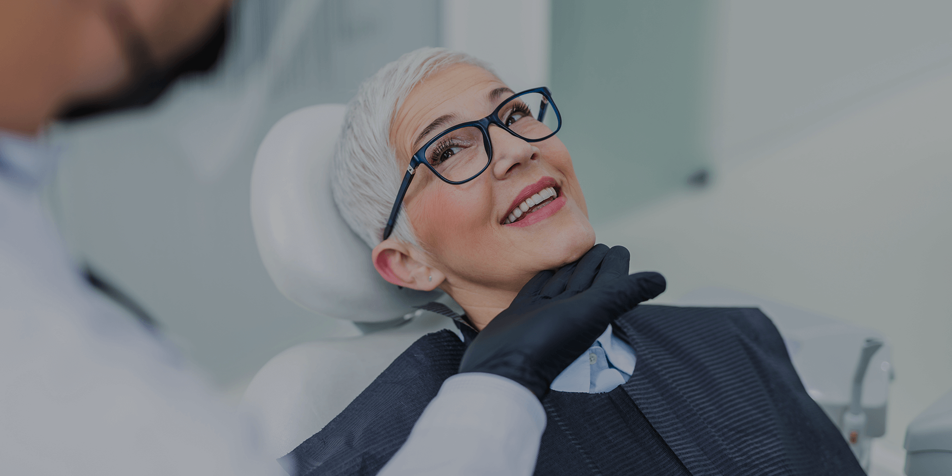 A dentish showing his patient's smile.