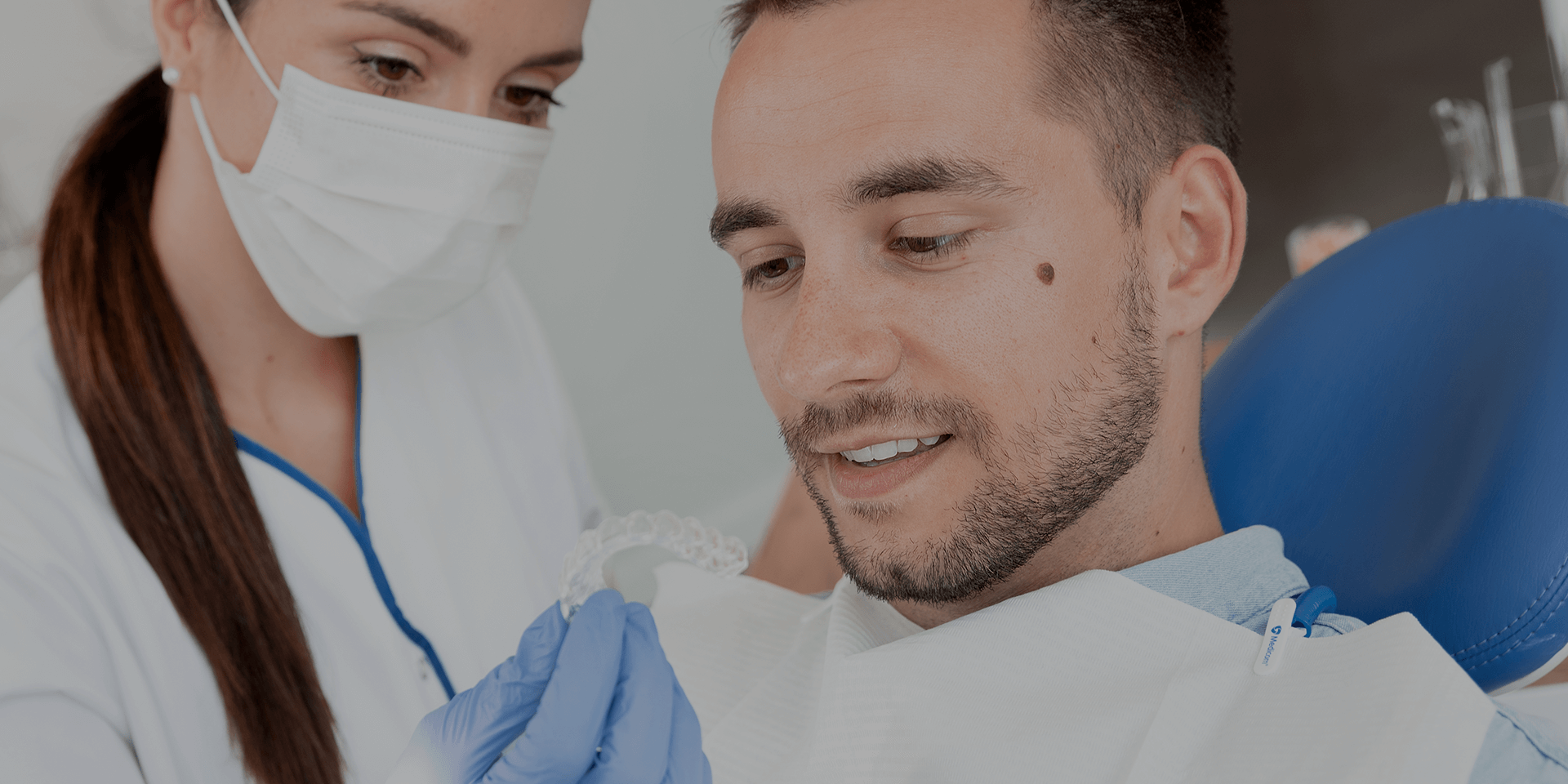 Dentist showing clear aligners to a patient