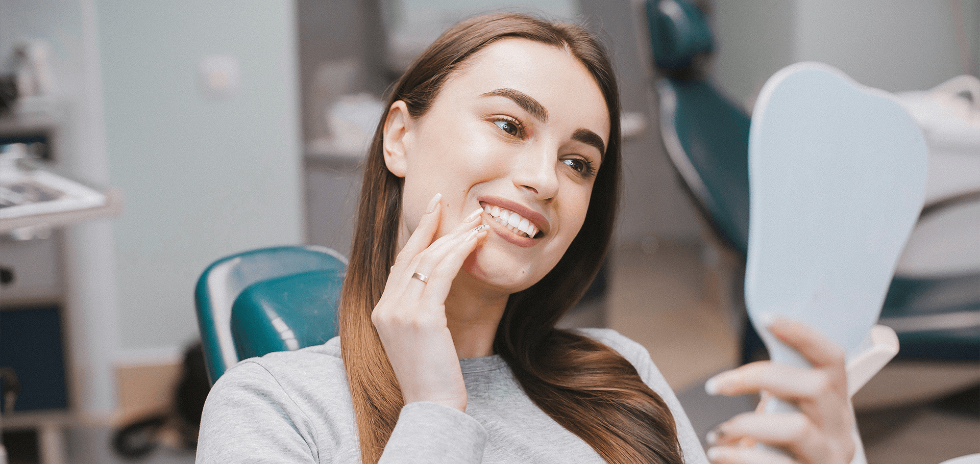 Woman smiling while looking at herself in a mirror.