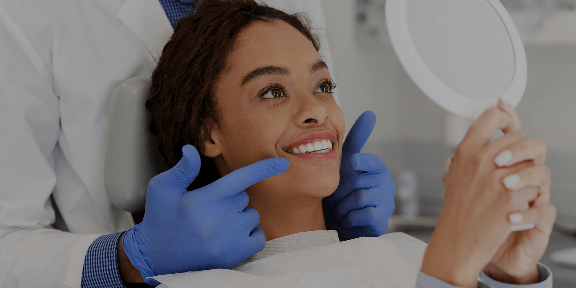 Woman smiling while looking at herself in a mirror.